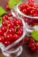 Red currant fruits on a wooden background