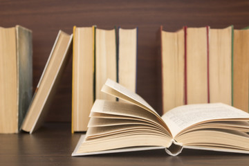 Old Books Background Books on wooden background with one open book Back to school concept