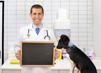 Vet holding chalkboard with