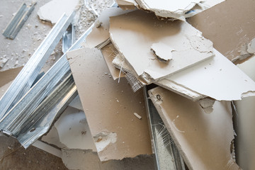 Heaps of rubble, pices of gypsum plasterboard and mounting rails. Mess  and demolition, ruins,...