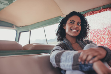 Smiling woman on roadtrip travelling by van © Jacob Lund