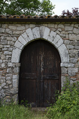 Fototapeta na wymiar Entrance of an antique stone house in Italy 