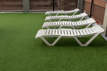 Four sunbeds on artificial grass in raini wether