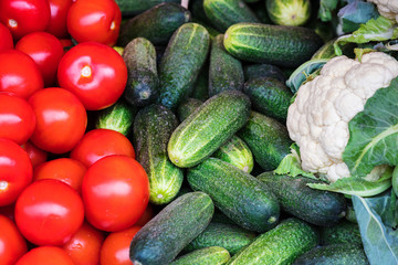 tomatoes, cucumbers and cauliflower on market