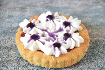 Fototapeta na wymiar Dessert with jam and cream. Dessert with cream in a basket. Cake in lilac tones.