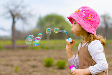 Girl playing with soap bubble