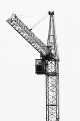 Construction crane on the construction site against the sky