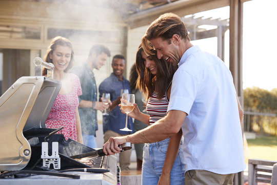 Group Of Friends Enjoying Barbecue At Home Together