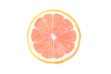 One half of a ripe lemon with a pink flesh is isolated on a white background.