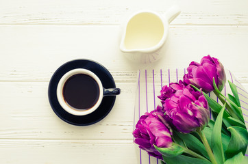 Cup of morning coffee and bouquet of spring flowers