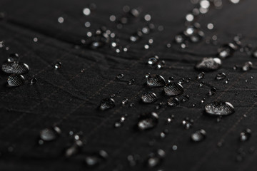 Rain Water droplets on  black waterproof fabric