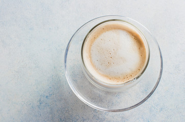 A cup of coffee in a white cup on metal dark background table. Copy space. Morning Drink Cappuccino