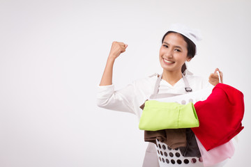 strong happy smiling confident woman guts pose; confident approved, acceptance hand gesture of domestic helper, woman housekeeper, woman maid holds laundry basket; confident laundry service staff