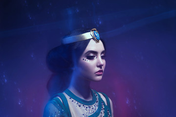 A girl in oriental attire, Queen of the storm. Princess Jasmine. The background is a twist and a...