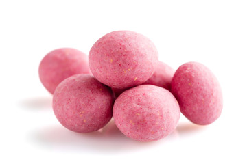 Heap of pink sugared almonds dragees isolated on white background