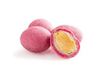 Heap of pink sugared almonds dragees isolated on white background