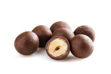 Heap of sugared hazelnuts dragees in chocolate isolated on white background