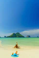 Fototapeta na wymiar Woman at the beach in Koh Poda island Thailand with out of office straw hat