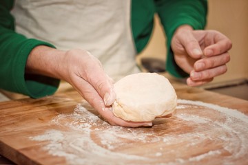 Pizza prepare dough hand topping in home.Blur concept.