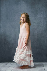 Fototapeta na wymiar Happy Little Girl In Pink Twirly Dress