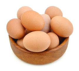 Raw eggs isolated in wooden bowl on white background