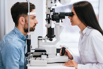 Doctor and patient in ophthalmology clinic - obrazy, fototapety, plakaty