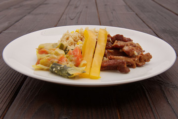 Seitan on the onion and couscous with corn