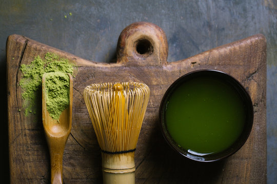 Preparing matcha tea with bamboo whisk