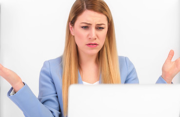 Fototapeta premium Attractive woman working at a laptop in the misunderstanding of a helpless gesture.