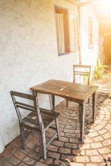 Vintage style wooden table and chair in the garden cafe.