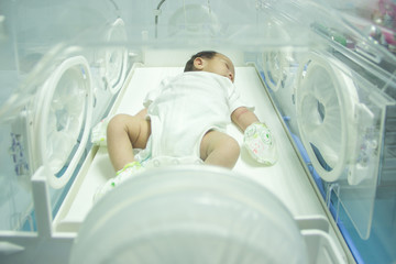  Cute baby newborn in a germ disinfection in a modern hospital.