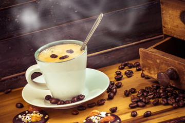 Hot coffee cup in a pretty vintage wooden decoration