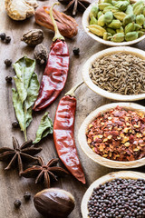Various whole indian spices on wooden table