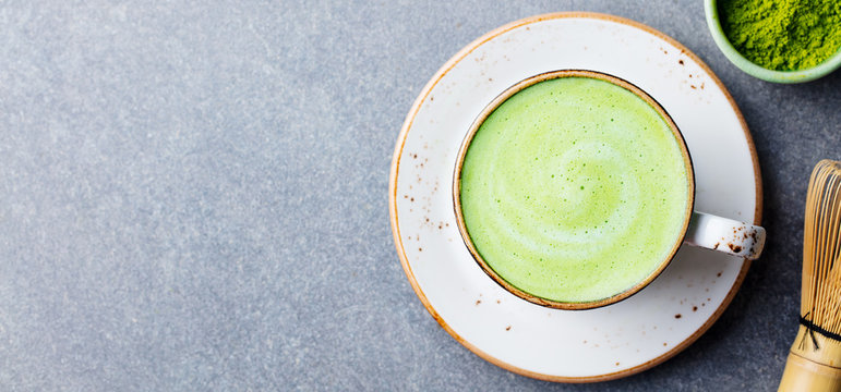 Matcha green tea latte in a cup. Top view. Copy space.
