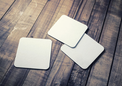 Blank white square beer coasters on wood table background. Stock Photo |  Adobe Stock