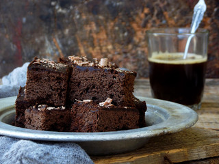 Pieces of cake chocolate brownies on wooden background. Homemade baking. Copy space