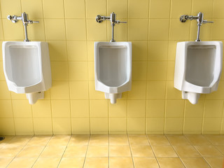 Close up row of outdoor white urinals men on yellow of wall public toilet.