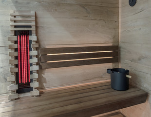 Modern wooden sauna with panel for the infrared radiation