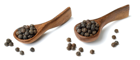 dried black peppercorns in the wooden spoon, isolated on white