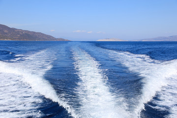 Beautiful sea during summer holidays. Back view from the yacht on a sunny day. Saronic Gulf, Greece.