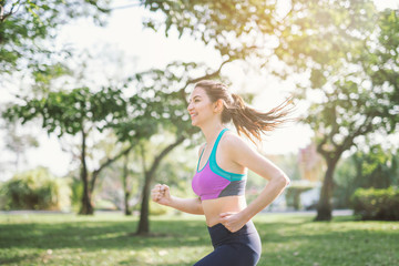 athletic woman running outdoors. Action and healthy lifestyle concept.Jogging run in park