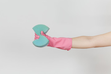 Close up of female hand in pink gloves holds and squeezes blue large sponge for cleaning and washing dishes isolated on white background. Cleaning supplies concept. Copy space for advertisement