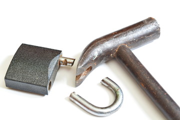 Broken padlock and claw hammer. Isolated. White background