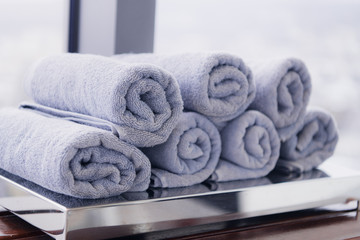 Obraz na płótnie Canvas close-up twisted towels on the shelf. Shallow focus