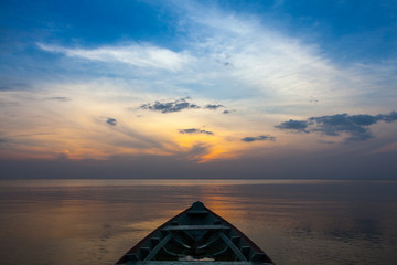 Small wooden boat on the Tapajós River at dusk near the city of Santarém, Pará, Brazil.