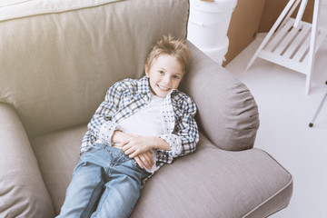 Cute boy relaxing at home