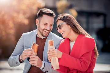 Happy loving couple enjoying breakfast in the city.