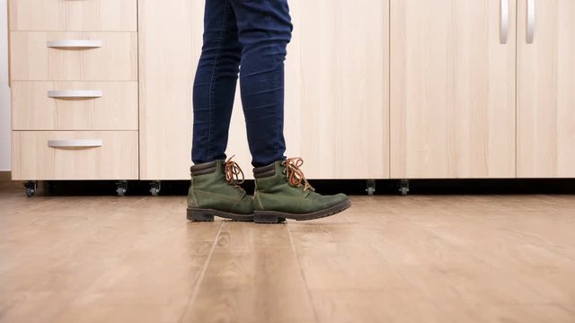 Close up traking shot of woman feets dancing on the kitchen floor