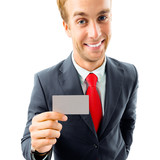 Businessman showing business or plastic card, with copyspace