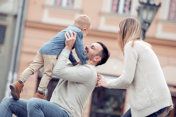 Happy young family spending time in the city.